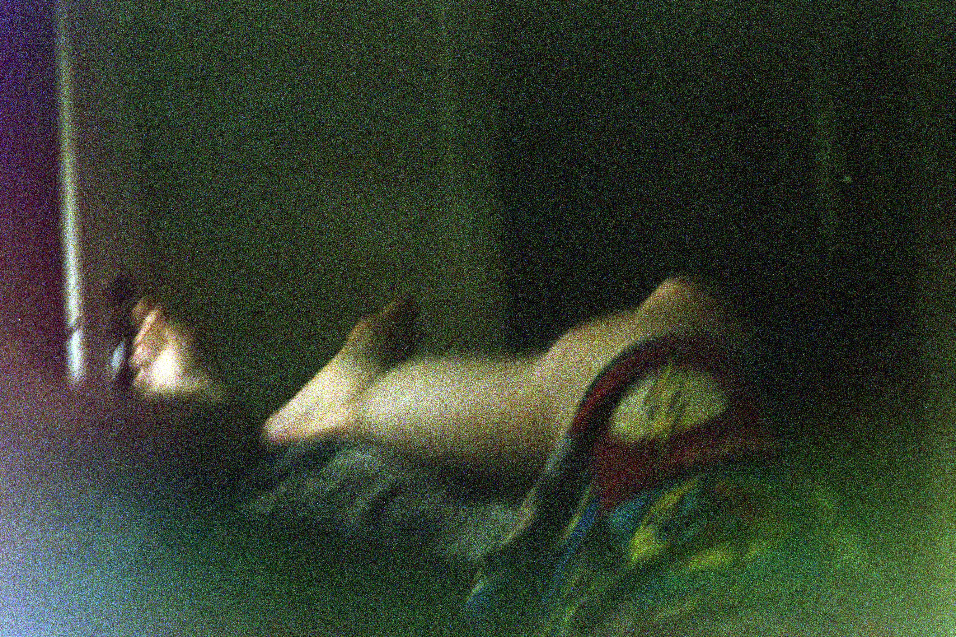 A blurry photo of my legs in pajamas, draped over the couch