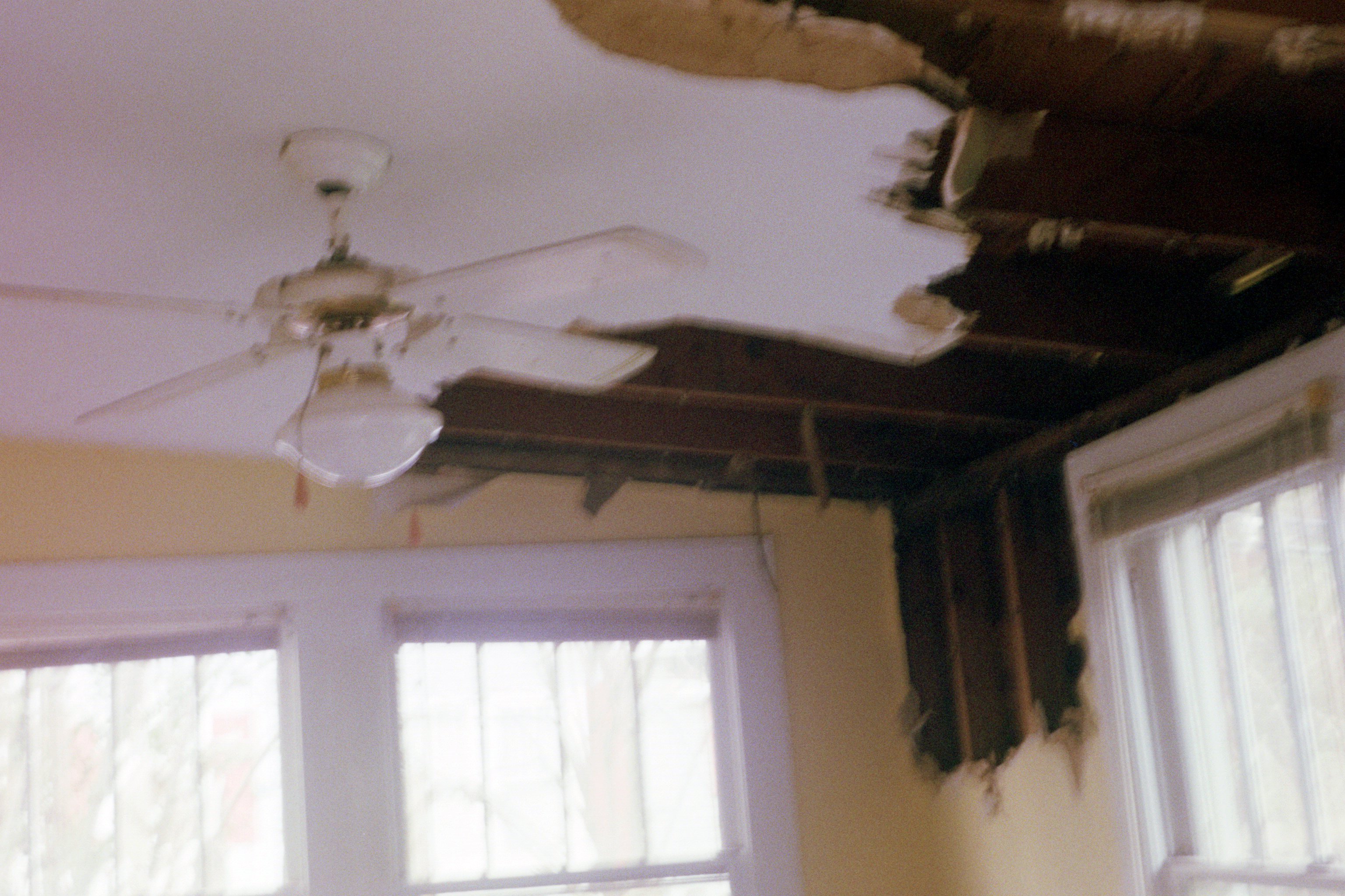Interior crumbling ceiling with fan