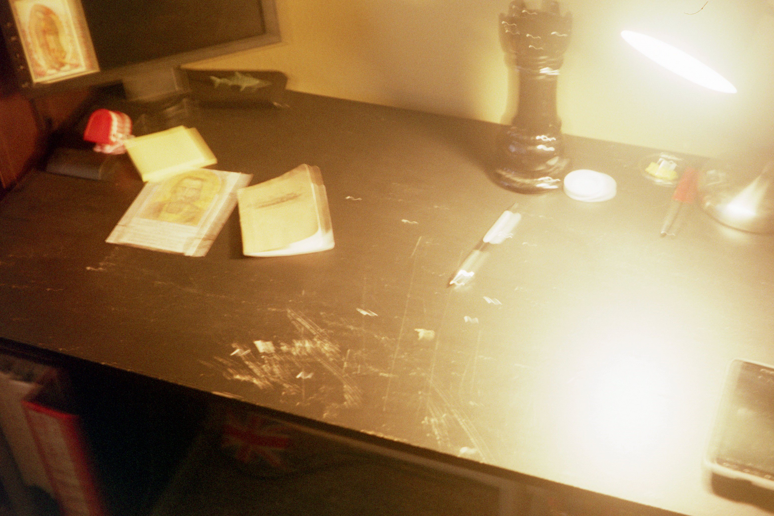 An extremely blurry photo of an extremely scratched-up desk